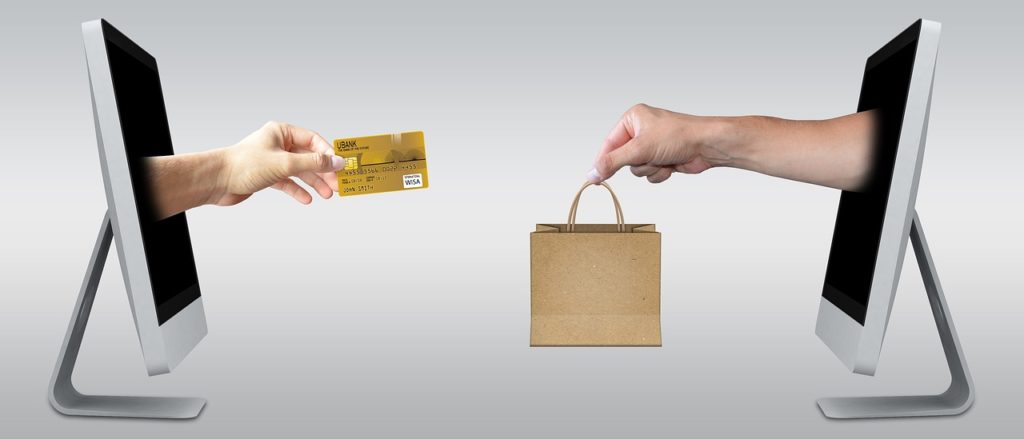 Improving sales. An image of a credit card and someone handing over the shopping. 